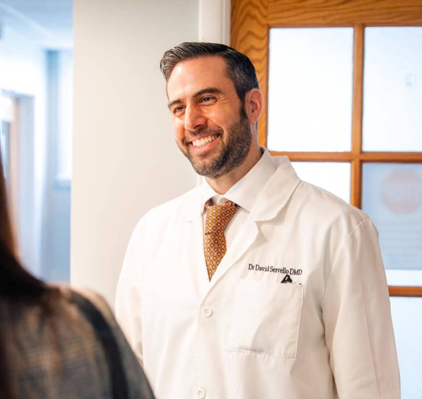Dr. Servello smiling during free consultation visit
